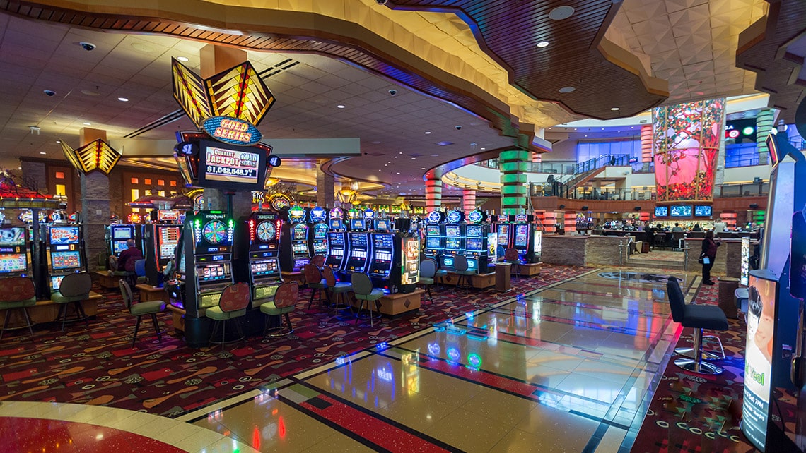 Slot machines gleam on a casino floor. 