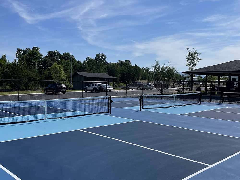 Blue pickleball courts in a resort setting