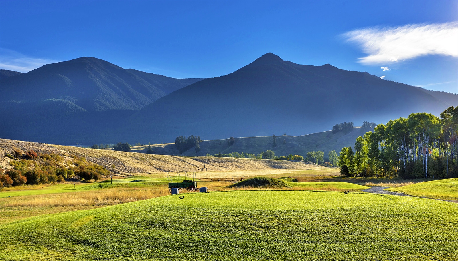 Golf course with mountains in background.