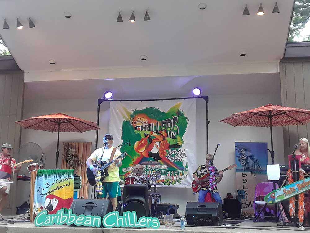 Live band playing in front of sign that says Caribbean Chillers